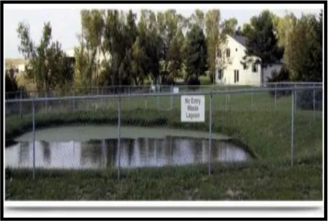 Image of a completed lagoon enclosed by a fence.