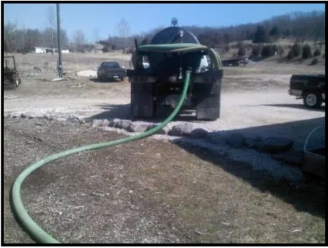Qualified SERVICE PROVIDER conducting routine MAINTENANCE and pumping an approved HOLDING TANK.